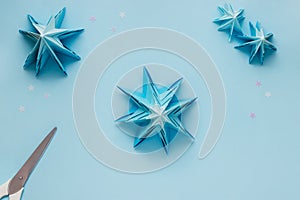 Simple origami 3D Christmas tree made from blue paper. Step by step instruction, step 20