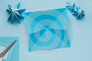 Simple origami 3D Christmas tree made from blue paper. Step by step instruction, step 6