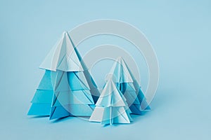 Simple origamy 3D Christmas tree made from blue paper. Step by step instruction, step 20