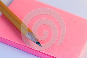 Simple pencil and paper note. Closeup pink paper note of sketch with wood pencil.