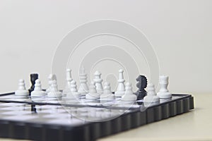 Simple Photo illustration for War, battle or politic situation concept, betrayer beyond the soldier, plastic magnetic small chess,