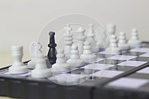 Simple Photo illustration for War, battle or politic situation concept, betrayer beyond the soldier, plastic magnetic small chess,