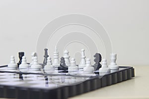 Simple Photo illustration for War, battle or politic situation concept, betrayer beyond the soldier, plastic magnetic small chess,