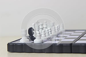 Simple Photo illustration for War, battle or politic situation concept, betrayer beyond the soldier, plastic magnetic small chess,