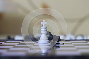 Simple Photo illustration for War, battle or politic situation concept, the winner, plastic magnetic small chess, critical