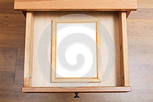 Simple picture frame in open drawer