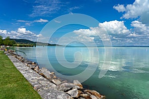 Simple picture about Lake Balaton in Hungary from Badacsony beach with blue sky and cloud refletion and stairs into the photo