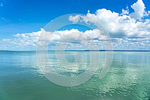 Simple picture about Lake Balaton in Hungary with blue sky and cloud refletion on the water photo