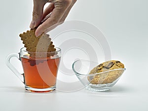 Simple pleasures dipping biscuit in tea