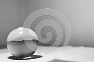 Minimalist Glass Sphere on a Textured Surface with Ample Copy Space.