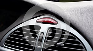 Simple red hazard warning lights button on car dashboard, triangle pictogram closeup, detail shot. Vehicle safety light alert