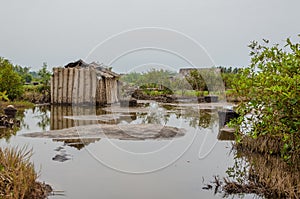 Simple reed mat homes of poor fishermen in wetlands of Benin