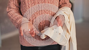 Simple repair of clothes, sew a button on a white blouse for women, a task for a young needlewoman