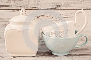 Simple rustic white and blue crockery, empty dishes. Two large bowls each other and porcelain jar with lid. Wooden background