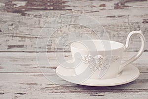 Simple rustic white crockery, empty dishes. A large cup of coffee in front angel. Wooden background, shabby chic, vintage