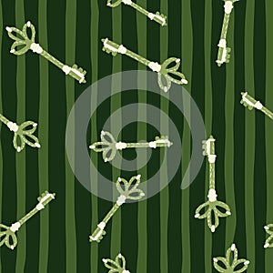 Simple seamless pattern with doodle keys stylized ornament. White and green colored elements on stripped background