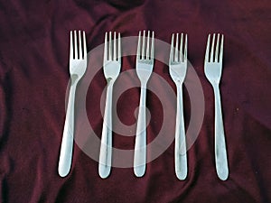 Simple set of fork and  isolated on violet background.