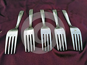 Simple set of fork and  isolated on violet background.