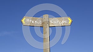 Brexit or Europe - Conceptual signpost with a blue sky background photo