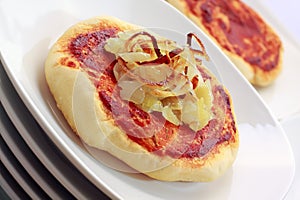 Simple small pizza (pizzette) with onion photo