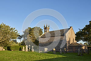 The simple small Victorian Parish Church of Dun with its Gothic features lit up in the Golden light of the evening Sun.