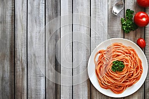 Simple spaghetti dish with tomato sauce and parsley, background left blank for adding message