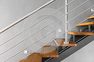 Simple staircase with chromed railing idea photo