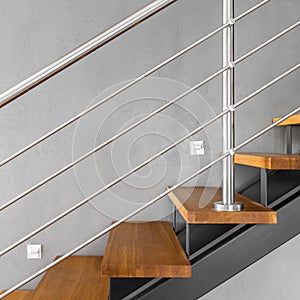 Simple staircase with chromed railing photo