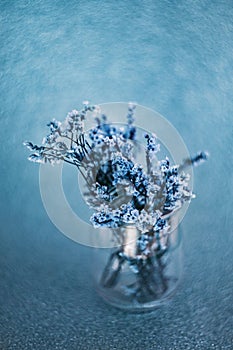 SImple stilllife shot with dried flowers and glass bottle