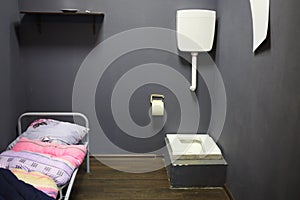 Simple stylized interior of a prison cell with a