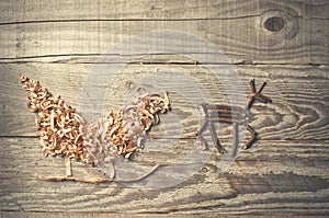 Simple symbols of Father Christmas sleigh arranged from sawdust