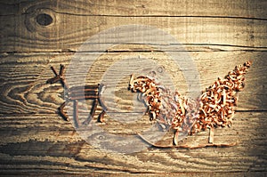 Simple symbols of Father Christmas sleigh arranged from sawdust