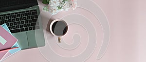 Simple Top view table - Creative flat lay office desk. Laptop, notebooks and coffee cup on pink background.