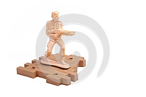 Simple traditional plastic toy soldier standing, holding a machine gun aiming, object isolated on white, cut out, people at war