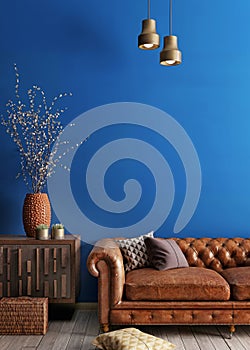 Simple urban style interior with brown sofa and blue wal.