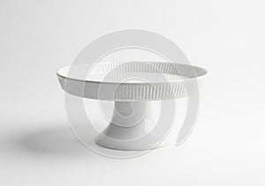 Simple white ceramic cake stand isolated on white background