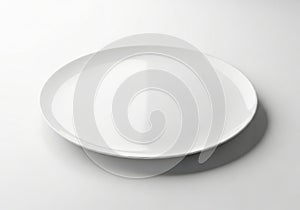 A simple white ceramic plate casting a soft shadow on a clean white surface