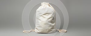 Simple white drawstring sack on plain background photo