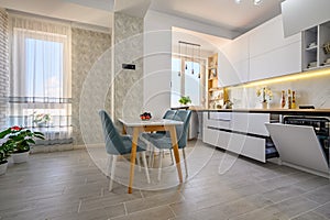 A simple white kitchen with drawers pulled out to their full length