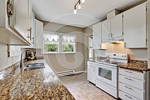 Simple white kitchen room with granite counters