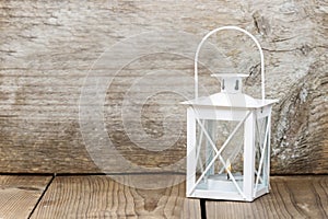 Simple white lantern on wooden background