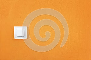 simple white switch on bright orange wall