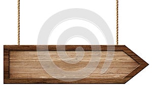 Simple wooden arrow signpost made of natural wood and with dark frame hanging on ropes