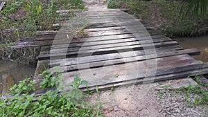 Simple wooden bridge for crossing drain pathway