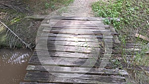 Simple wooden bridge for crossing drain pathway