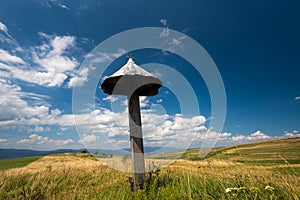 Simple wooden catholic cross on the top of a hill in Transylvania, Romania