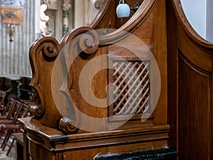 Simple wooden confessional in a church closeup detail, nobody, no people. Confession, confessing sins religious concept photo