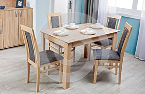 Simple wooden dinning table and chairs in interior - studio
