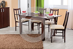 Simple wooden dinning table and chairs in interior - studio ambient room