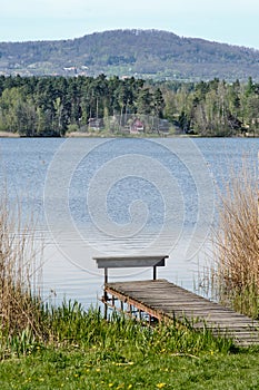 A simple wooden pier on a shore of lake or pond in Holany, Czech Republic